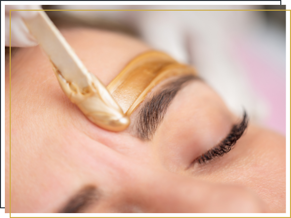 woman getting an eyebrow waxing